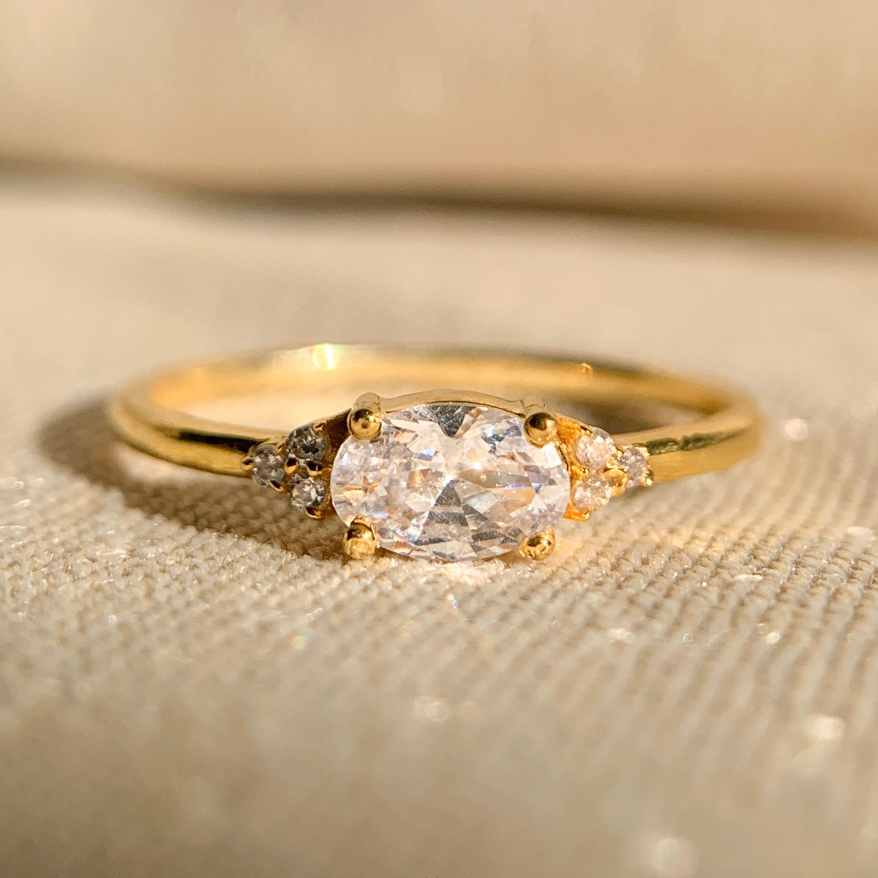 East west oval diamond engagement ring in yellow gold